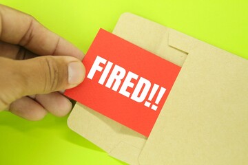 red envelopes and paper with the word fired. the concept of dismissal or resignation