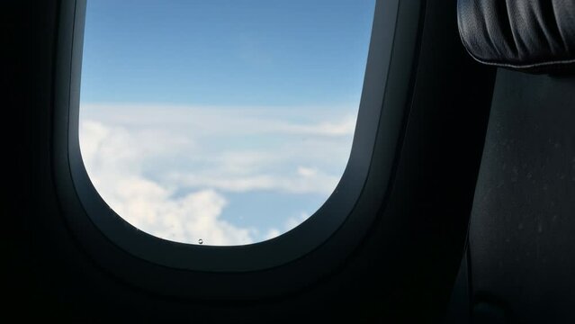 airplane flight flying trip travel above clear blue sky with beautiful cloud, looking at view through window of plane