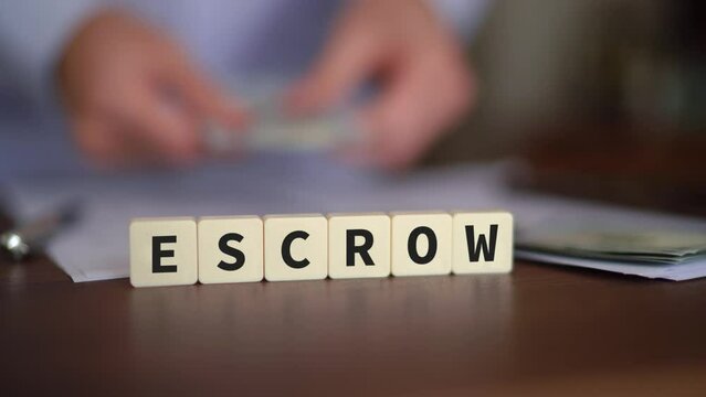 Concept of money in Escrow. Selective focus with cash on the background.