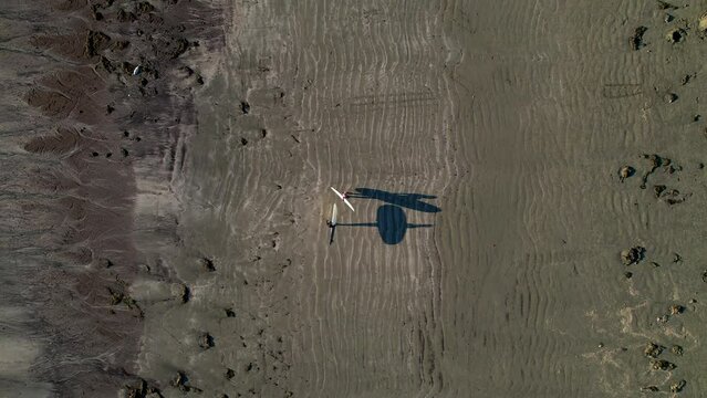 A Pair of surfers walking on the beach