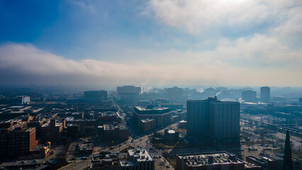 establishing aerial drone shot of Chicago downtown during a cloudy day with the sun piercing through the clouds. the skyscrapers are a beautiful part of Chicago architecture 