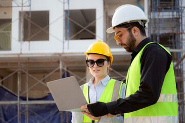 Team of architect or engineer looking laptop for inspection and planning construction at construction site, contractor or builder examining and checking project development house, industry concept.