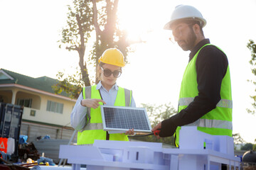 Team young engineer or architect meeting and planning installation solar panel at construction site, engineer talking and discussing with partner for installation solar cell, industry concept.