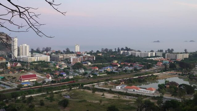 View from the mountain to the city of Hua Hin in Thailand and a moving train