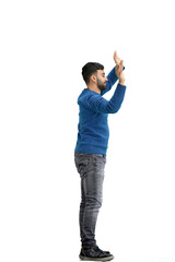 A man, full-length, on a white background, waving his arms