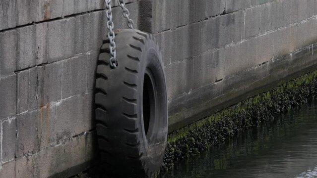 Dock bumper at Aarhus harbour, hangs on the side of the harbor edge.