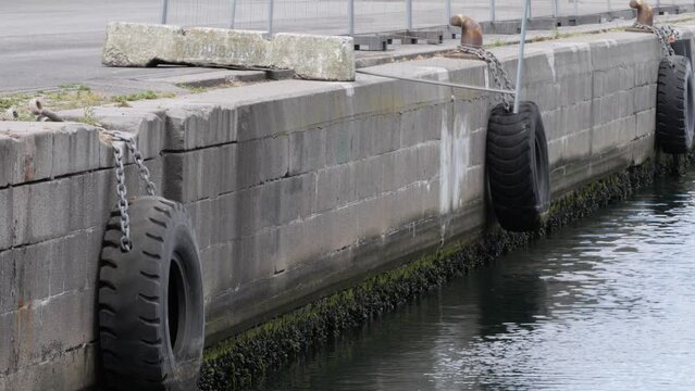 Dock bumpers at Aarhus harbour, hangs on the side of the harbor edge.