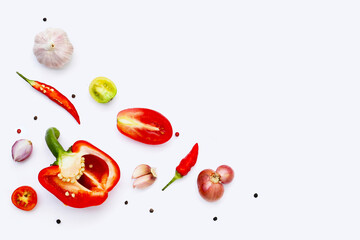 Various fresh vegetables and herbs on white background.