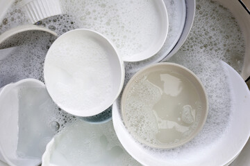 Dish washing, Dirty dishes soaking in kitchen sink.