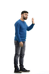 Naklejka premium A man, full-length, on a white background, waving his hand