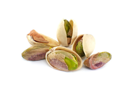 Randomly spread pistachios isolated on white