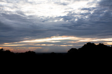 Panoramic cloudscape with the sun rays radiating from behind the cloud.Phnom Bakheng sunset view Angkor Wat, Siem Reap, Cambodia