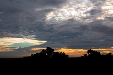 Panoramic cloudscape with the sun rays radiating from behind the cloud.Phnom Bakheng sunset view Angkor Wat, Siem Reap, Cambodia