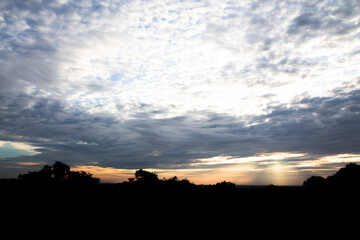 Naklejka premium Panoramic cloudscape with the sun rays radiating from behind the cloud.Phnom Bakheng sunset view Angkor Wat, Siem Reap, Cambodia