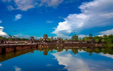 Reflections of the jungle over the broad moat of the ancient temple of Angkor Wat, in Cambodia