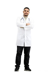 The doctor, in full height, on a white background, crossed his arms