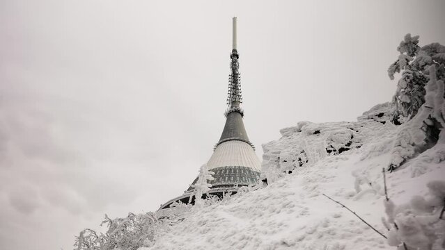 Hyperboloid shape television transmitter tower spire in winter landscape