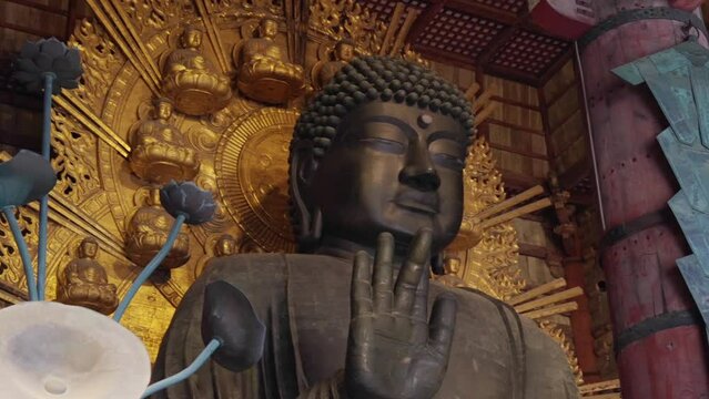 Giant Buddha statue at Tōdai-ji temple, Nara, Japan, with intricate gold details and serene expression