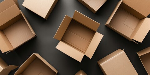 Empty open brown cardboard boxes on dark gray color background. Top view - obrazy, fototapety, plakaty