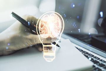 Creative idea concept with light bulb and human brain illustration and with hand writing in...