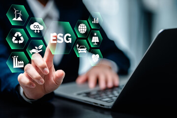 Businesswomen using laptop computers with ESG icon concepts for Environment, Social, Governance, net zero, carbon neutrality goals, development business sustainable environment concept.