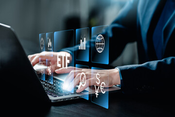 ETF Exchange traded fund stock market trading investment financial concept, Businessman using a laptop analyze index fund with icons of ETF virtual screen