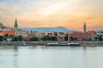 Danube River in Budapest city, Hungary. Urban landscape with old historical buildings. Reddish sky in the background.
