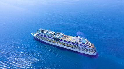 Aerial view of a luxury cruise ship leaving the port. and sailing on an ocean cruise go to the...