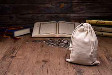 Ramadan, Hands holding a money bag for zakat, Islamic zakat concept. Muslims help the poor and...