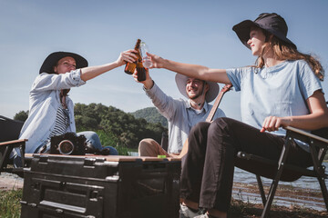 Group of travallers camping with friends they join drinking and playing guitar together with...