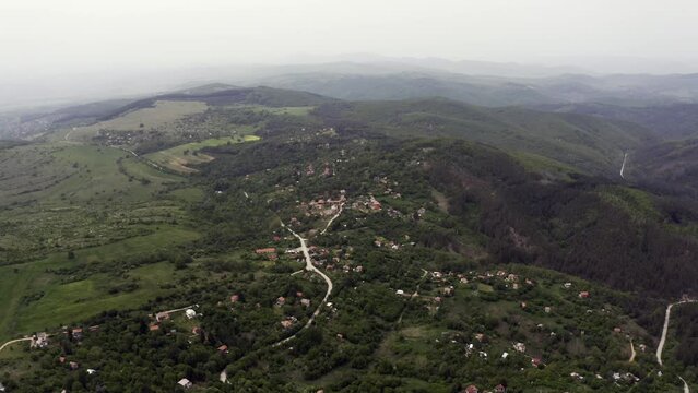 View from the top of an approaching drone shot of the village of Tsarichina, a place known for some mysterious paranormal activities in the countryside of Bulgaria.