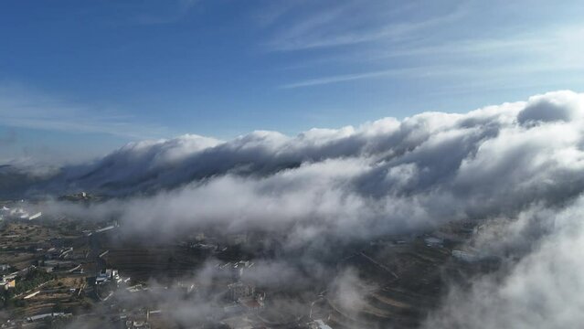 Stunning landscape of clouds over houses in Abha city on sunny day. Aerial, static , Aseer region Vision203