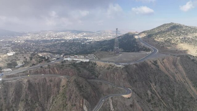 Aerial flying forward winding roads that reach Abha, Asir Province, Saudi Arabia