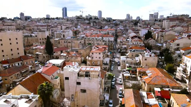 old neighborhood in the center of Jerusalem, red roofs and towers in the background. Mea Shearim is a 150-year-old neighborhood. neighborhood of ultra-orthodox Jews, religious and Hasidic. Drone shot