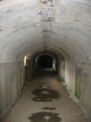 Dark narrow concrete underpass, underground Stone tunnel Inside the Vladivostok fortress, Russia