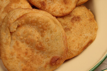 Deep fried stuffed pancakes aloo dal puri Bengali snacks on enamel tin metal plate