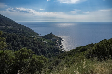 Corsica, a traditional village in the mountain, ancient fortress, with the sea in background
