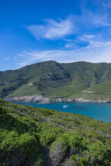 Fototapeta na wymiar Corsica, seascape in the cap Corse, a beautiful creek with a boat, transparent water, in summer 