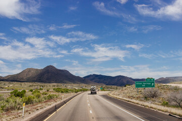 Beautiful blue sky with fluffy clouds over the highway on a spring day. Arizona sign. Scenic road in Arizona, USA on a sunny summer day. Arizona, USA - 17 April 2020