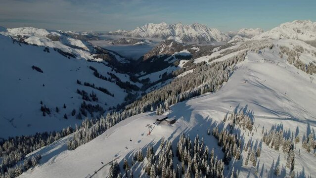 Ski Lift On The Resort Town Of Saalbach-Hinterglemm With Kleines Rothorn And Matterhorn Mountains In The Background.