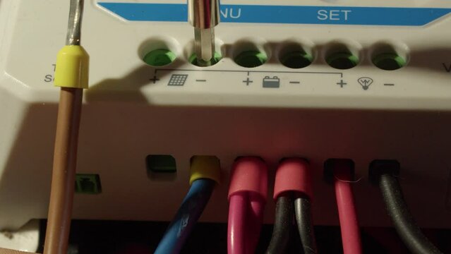 Wires from solar panels are attached to solar power controller unit