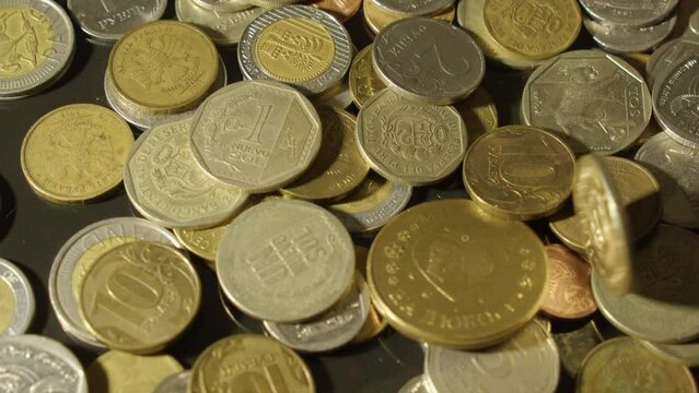 Creative coin designs: Coins from around the world are thrown on table