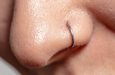 Close-up of a nose piercing. Macro