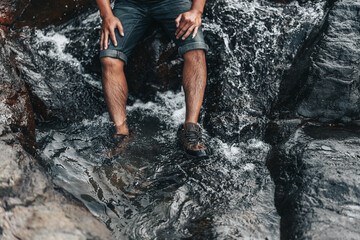 Hikers relax in the stream flowing from the waterfall. hiking concept.