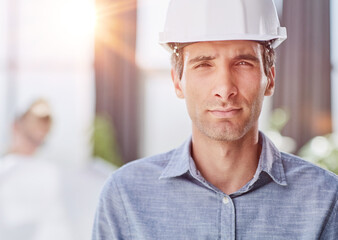 portrait of a confident businessman in a protective helmet