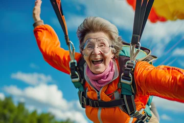 Fotobehang elderly woman skydiving with a parachute. Extreme sport. © YULIYA