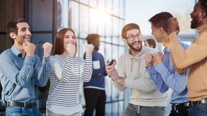 Business people celebrates and clench their fists in the air as a winning team