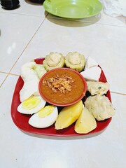 Siomay is a typical Indonesian food made from cabbage, potatoes, eggs, bitter melon and tofu boiled in peanut sauce