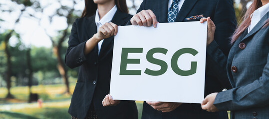 Group of business people stand united, holding eco-friendly idea and concept for environmental...