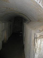 Obraz premium Dark narrow concrete underpass, underground Stone tunnel Inside the Vladivostok fortress, Russia